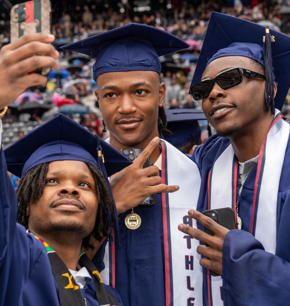 graduates get together to take a selfie.