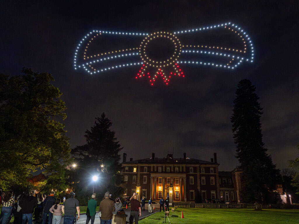 Drones form the image of a diploma in the sky.