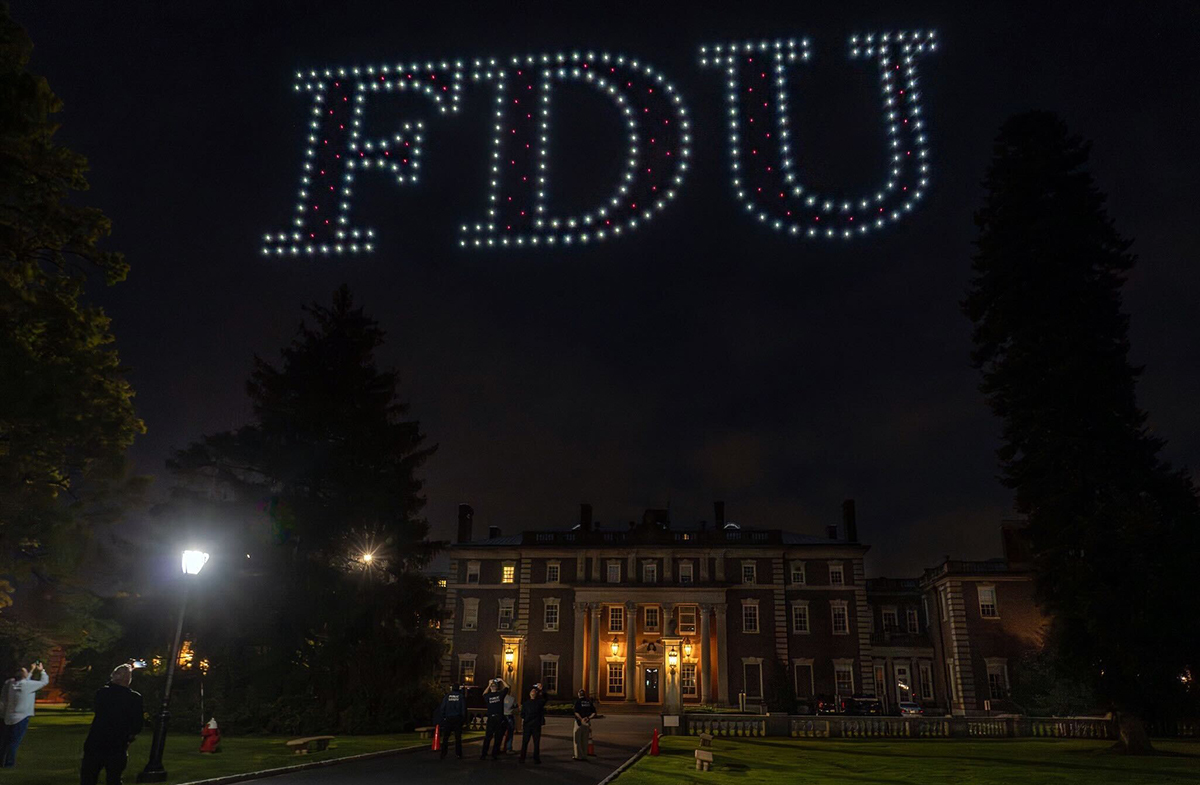 A drone light show above the Florham Campus spells out FDU.