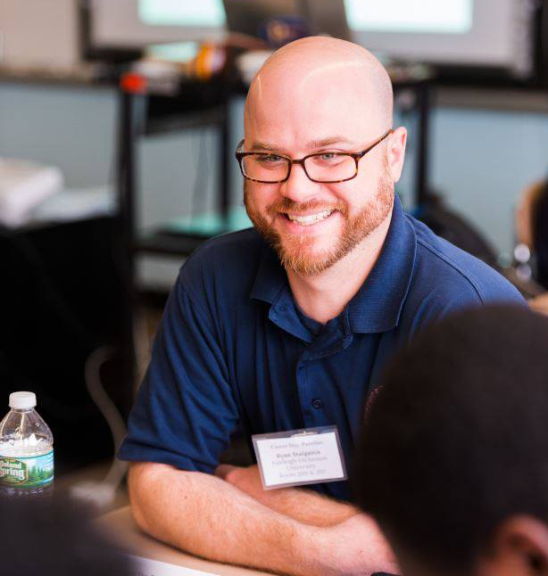 A bald man wearing glasses gives career advice.