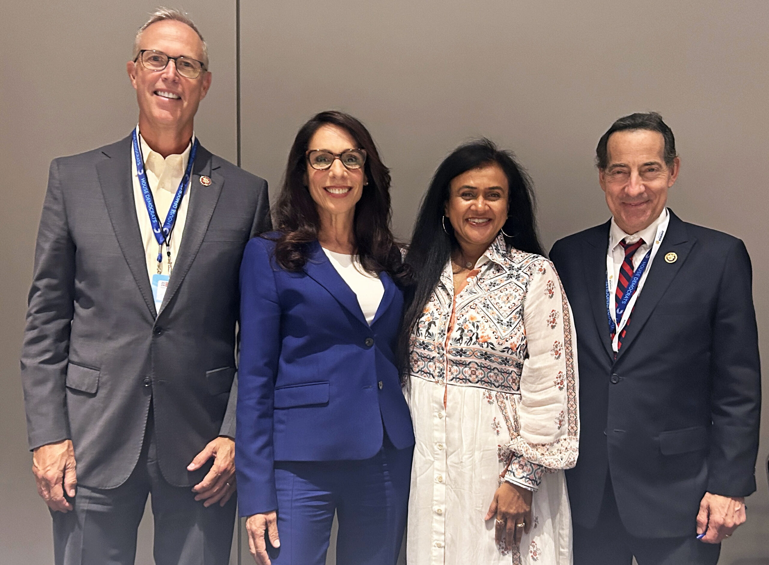 Four panelists, two men and two women, pose for a photo.