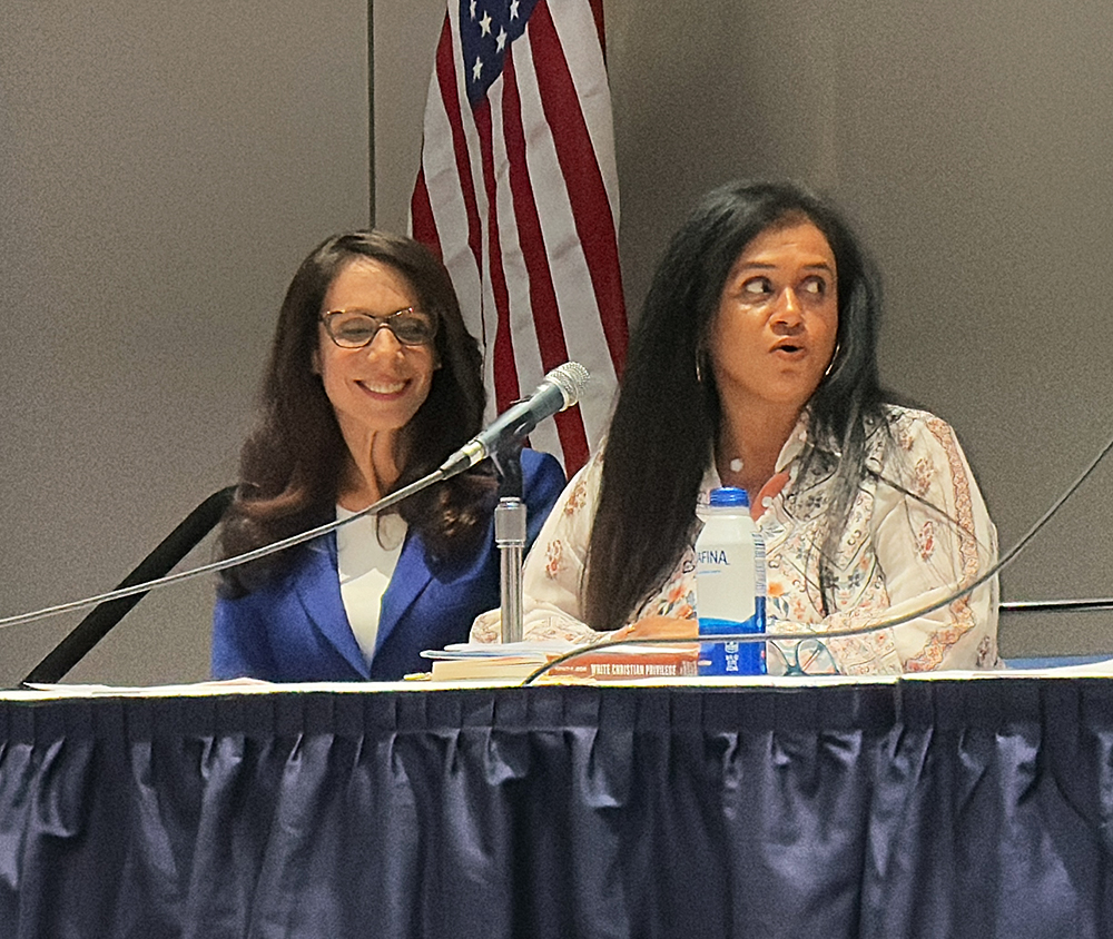 Two women sit on a panel.