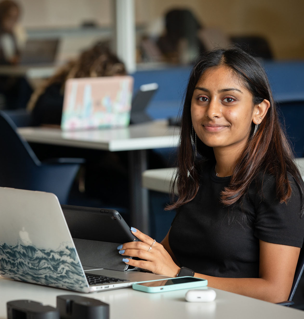 A student sits with her laptop in the Monninger Center.