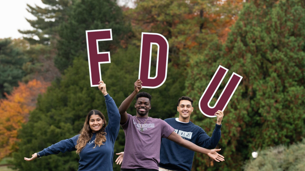 Students hold up large letters spelling F-D-U!