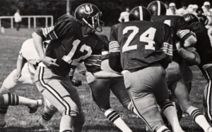 football players in the middle of a game. the photo is in black and white.