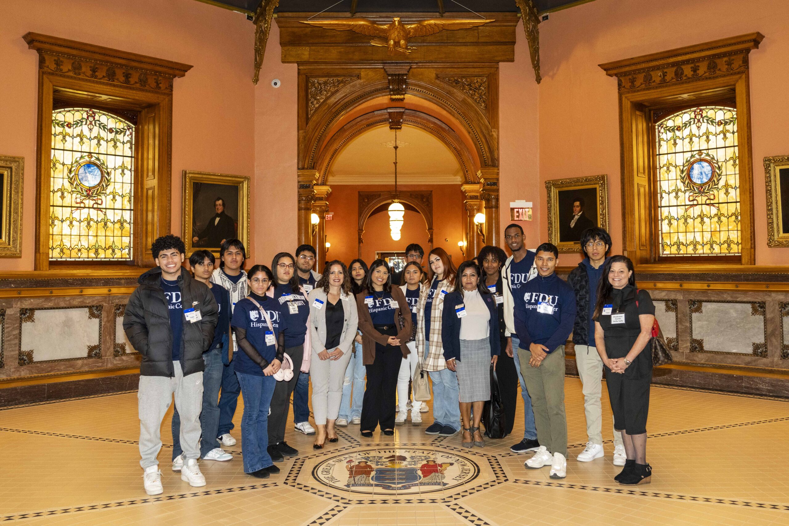 A group of Hispanic students pose for a photo at the state capitol.