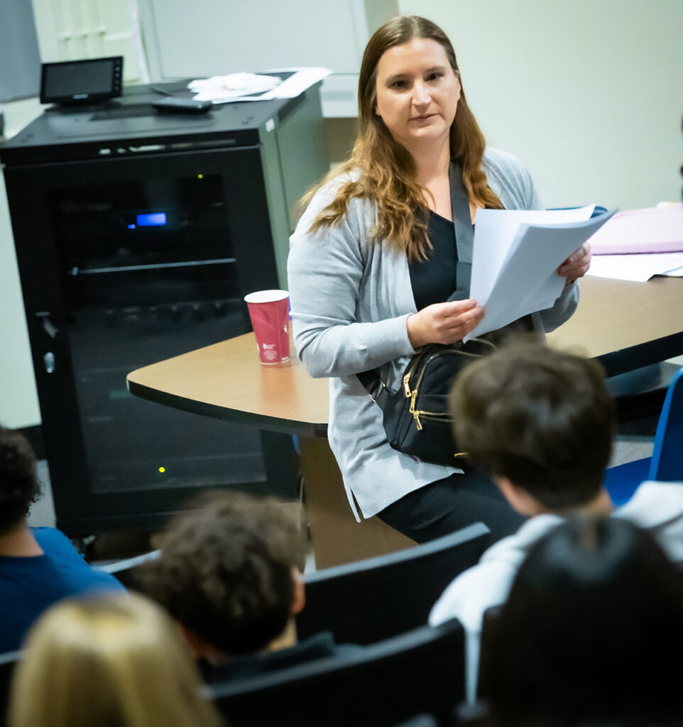 A woman gives instructions to a young class.