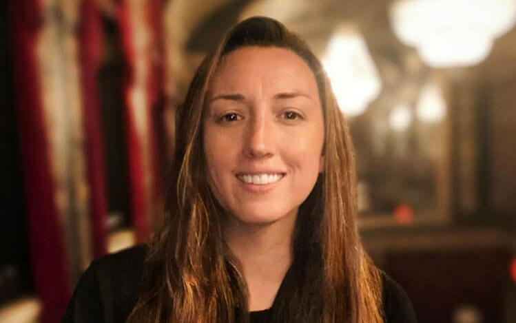 Portrait of a young woman with long hair.