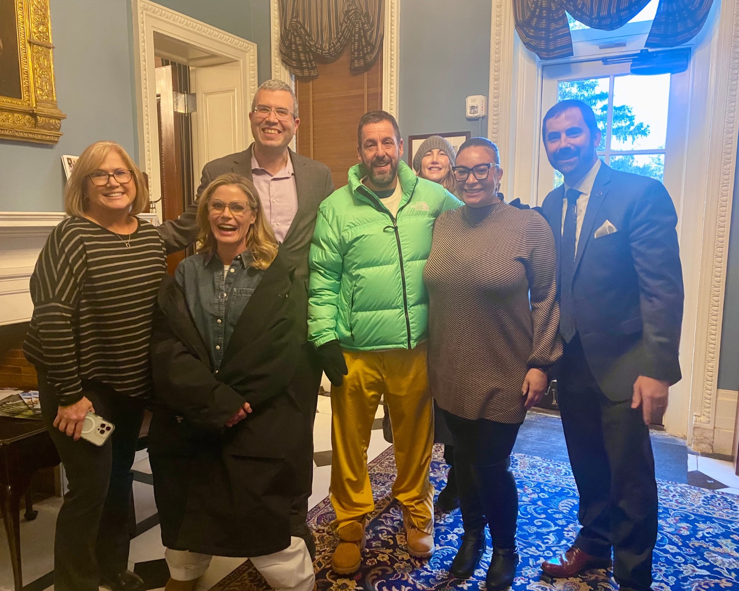 Adam Sandler, Julie Bowen, FDU President Michael Avaltroni and others stand for a photo.