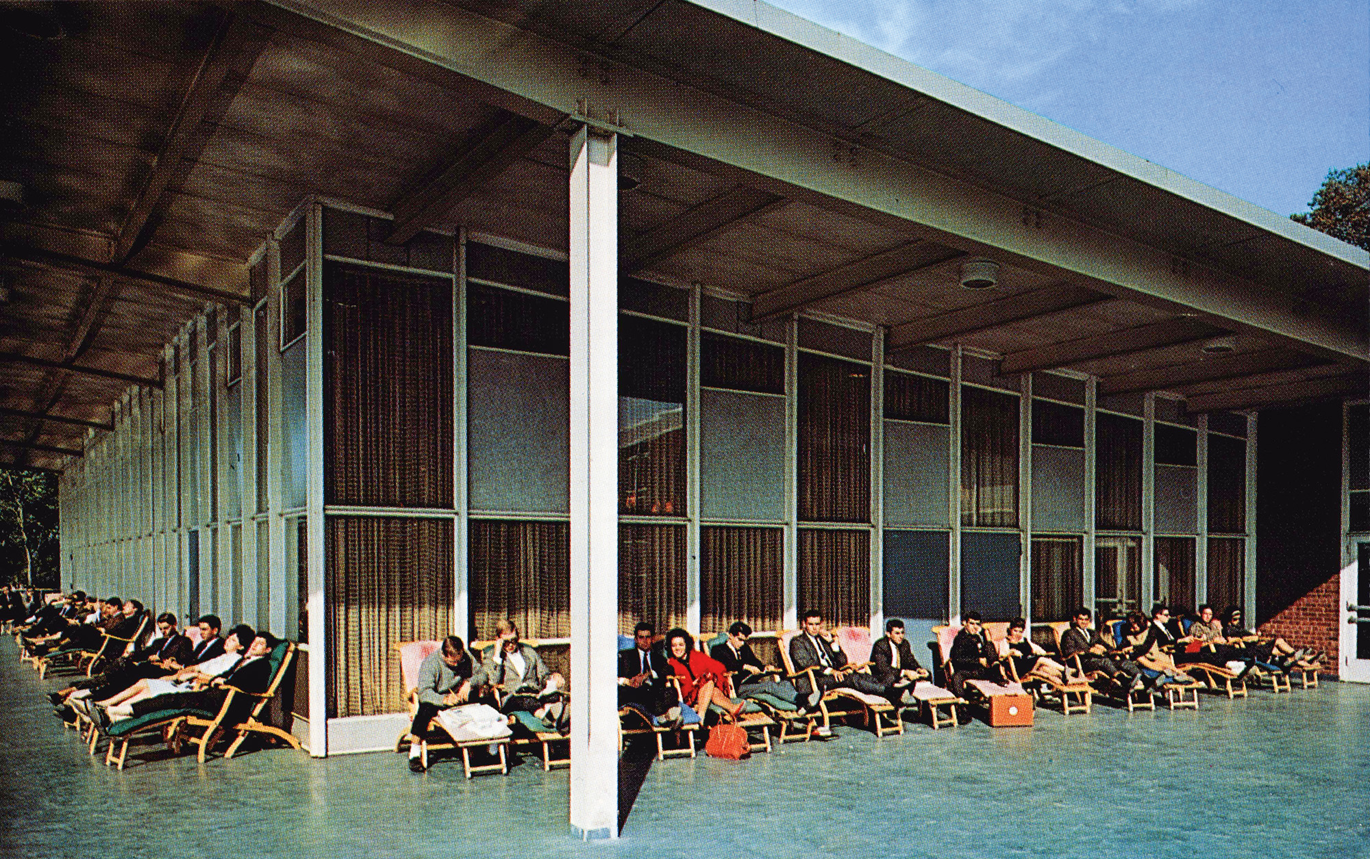 A vintage campus postcard shows students relaxing on a sun deck.