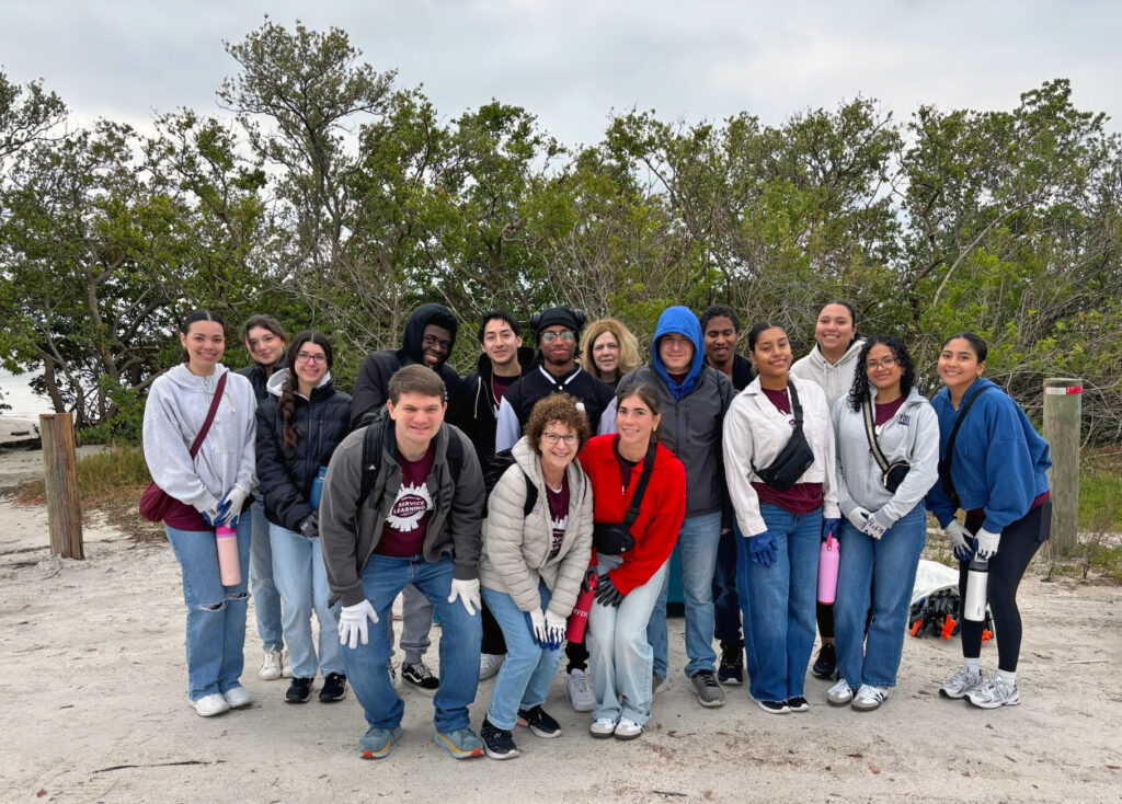 A group photo of beach clean-up volunteers.